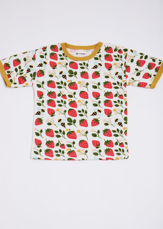 Front of short sleeved t-shirt featuring an all over strawberry and bees print with contrast honey neck and sleeve trim.