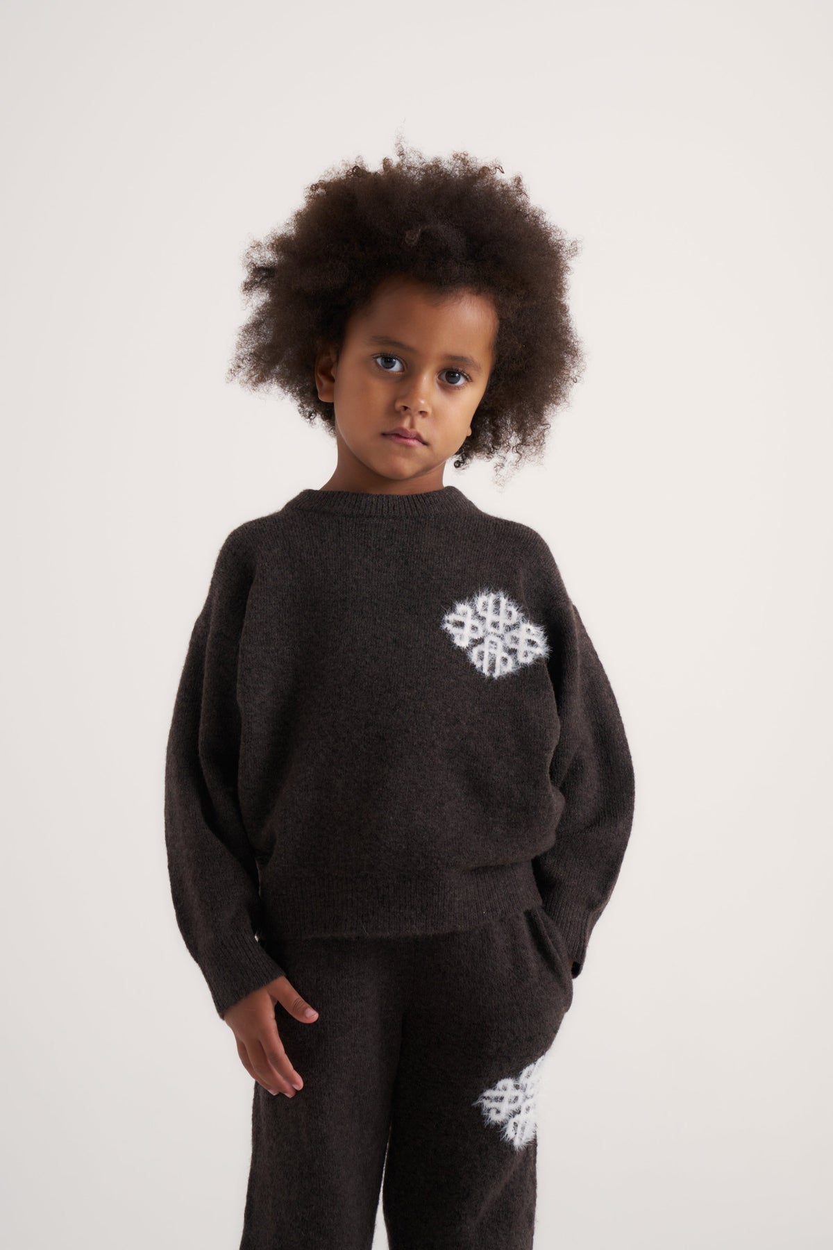 Kids Emblem Fluffy Knit Crew in Brown – model front view styled with the matching joggers