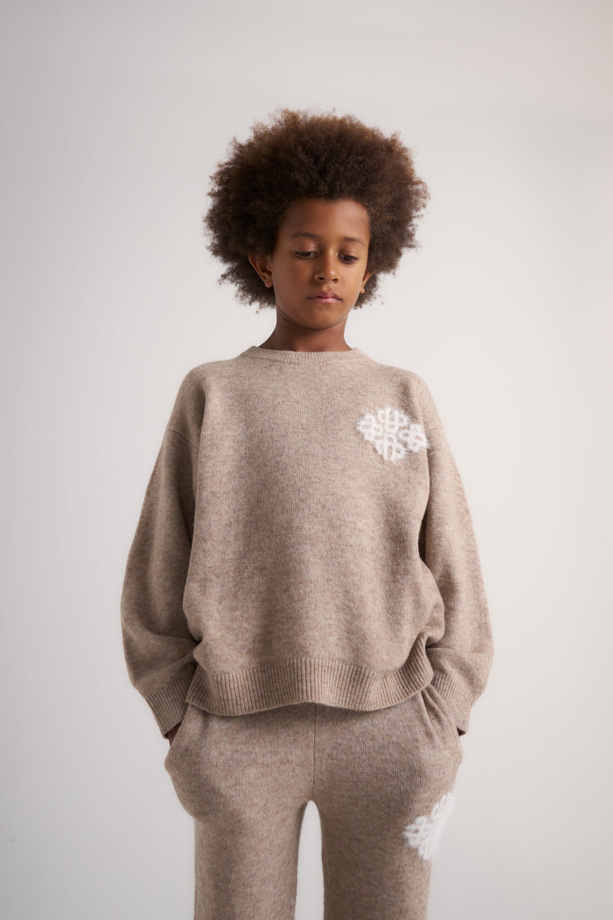 Junior Emblem Fluffy Knit Crew in Beige – model front view styled with the matching joggers