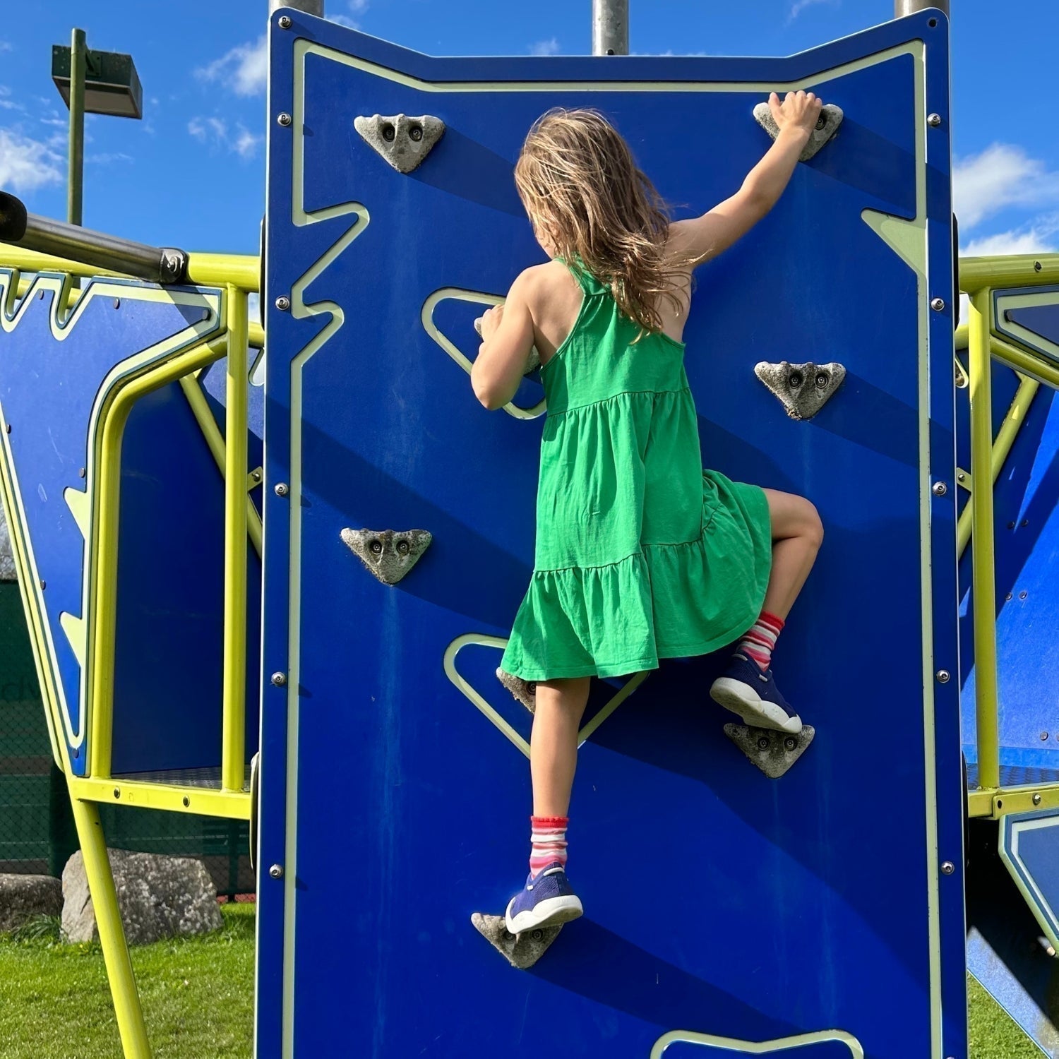 Blue Dubs Flex wide-fit sensory-friendly kids trainer, girl climbing