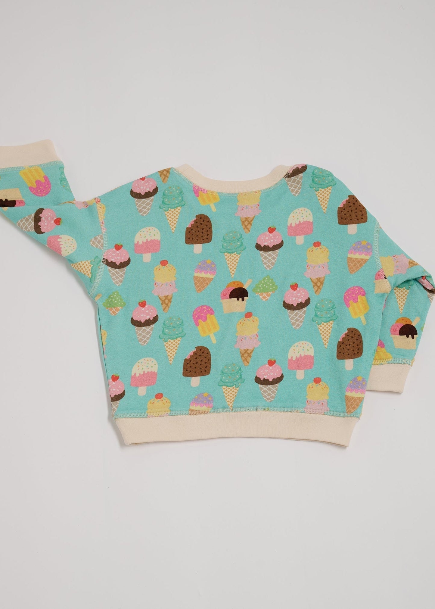 Back of sweatshirt featuring an all over turquoise ice cream print with contrast vanilla neck and sleeve trim.