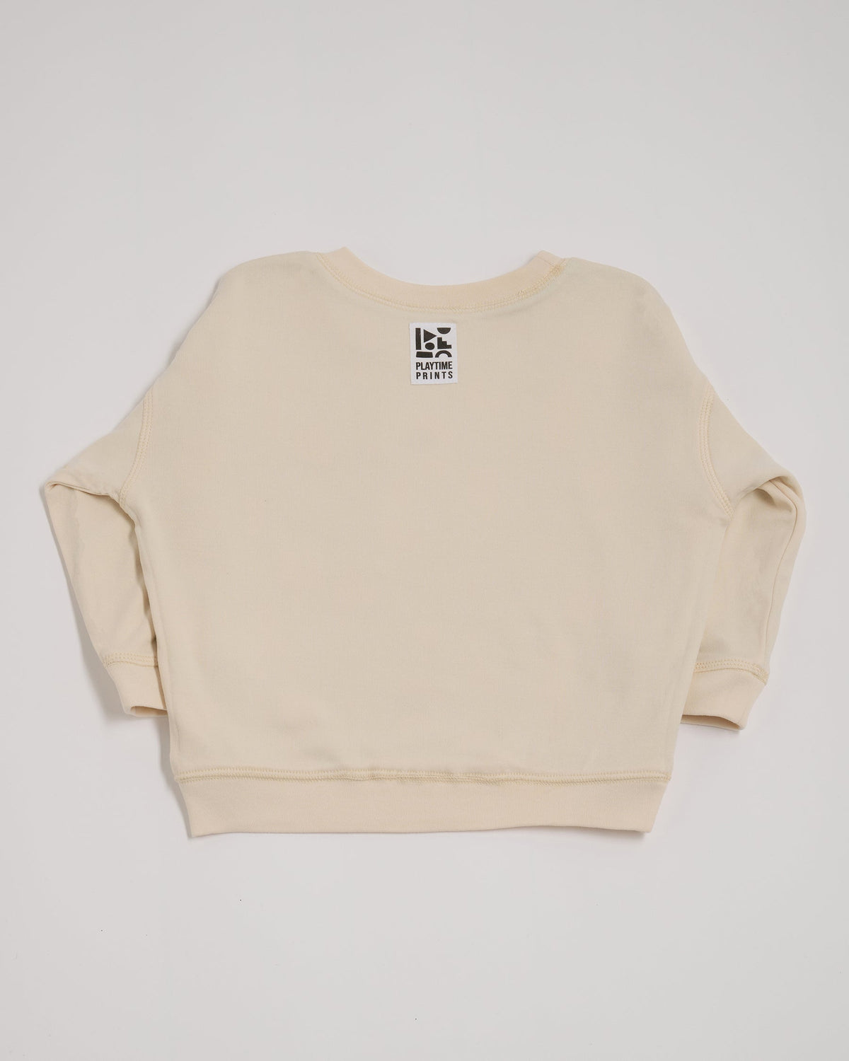 Back of ecru sweatshirt showing Playtime Prints brand label.