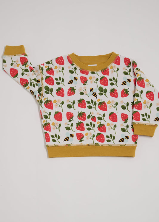 Front of sweatshirt featuring an all over strawberry and bees print with contrast honey neck and sleeve trim.