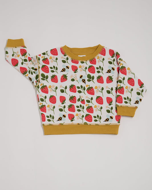 Front of sweatshirt featuring an all over strawberry and bees print with contrast honey neck and sleeve trim.