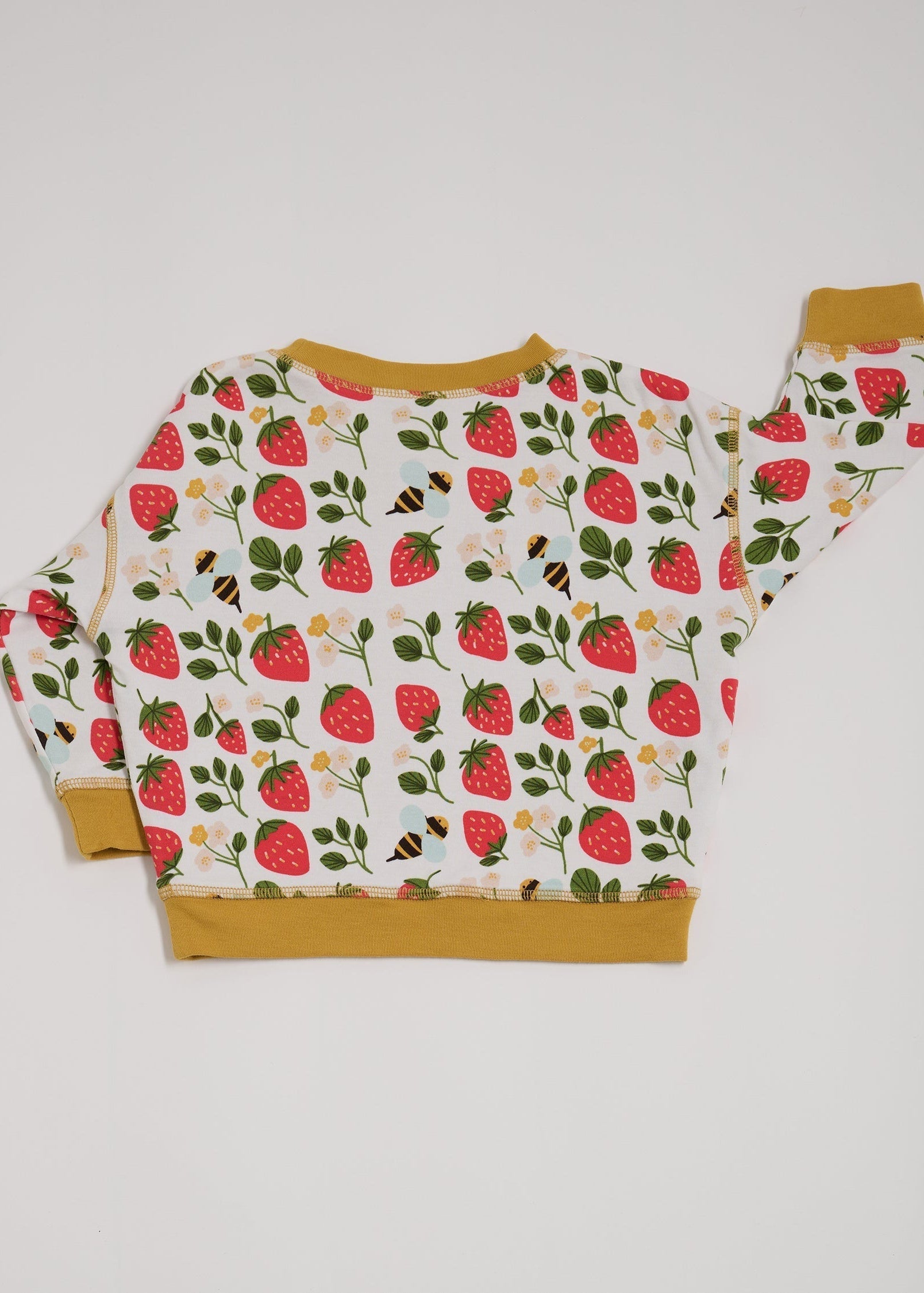 Back of sweatshirt featuring an all over strawberry and bees print with contrast honey neck and sleeve trim.