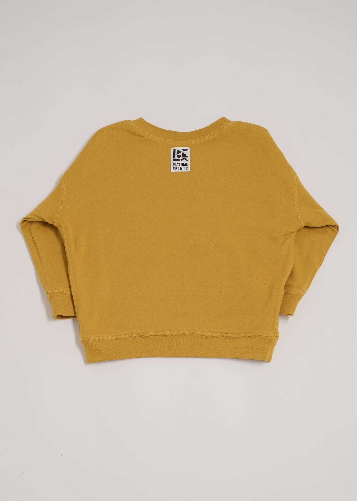 Back of honey coloured sweatshirt showing Playtime Prints brand label.