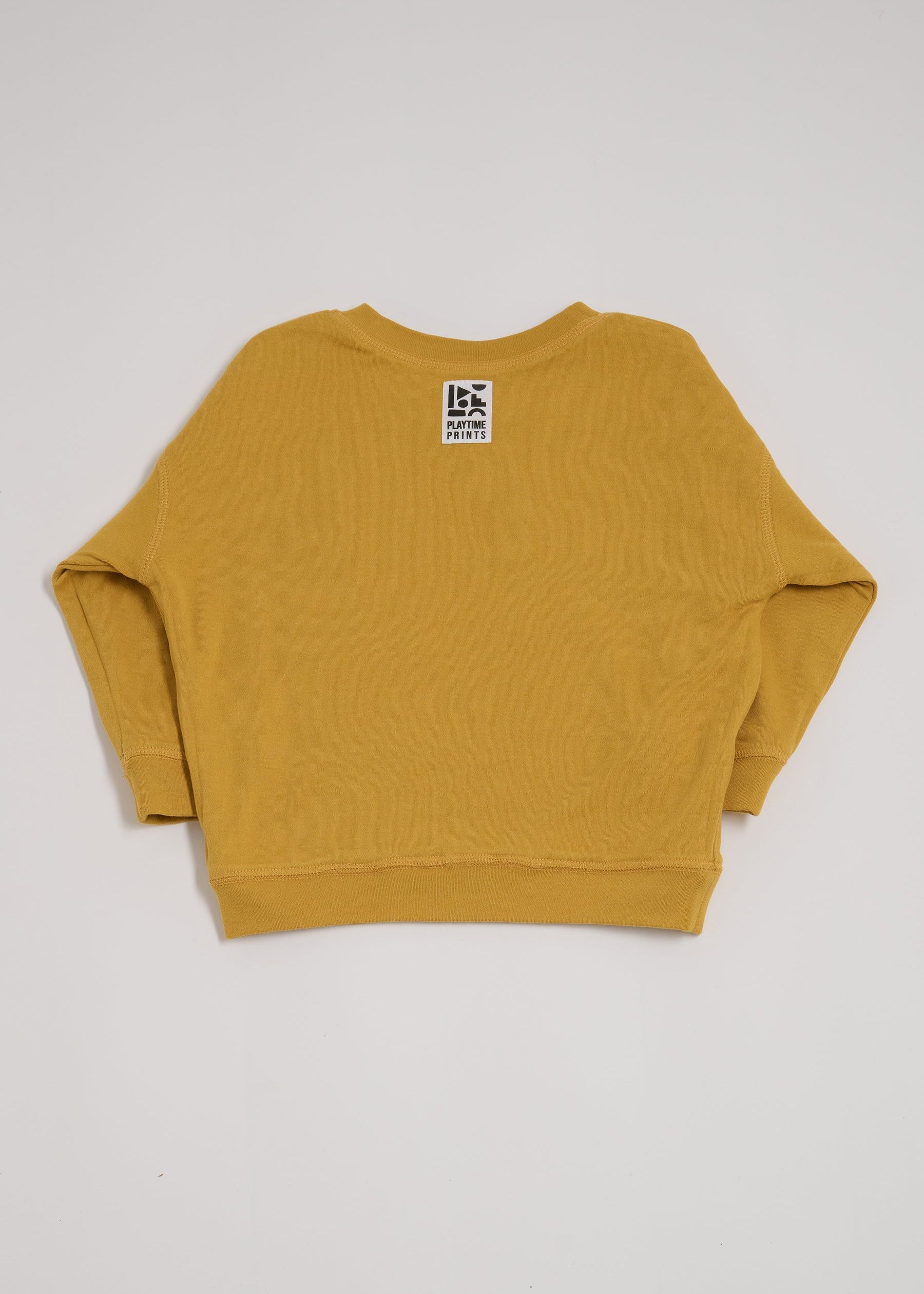 Back of honey coloured sweatshirt showing Playtime Prints brand label.