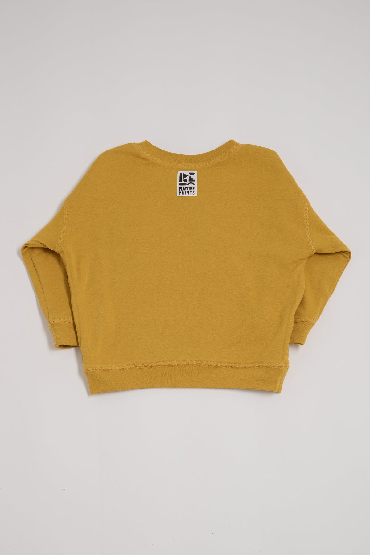 Back of honey coloured sweatshirt showing Playtime Prints brand label.