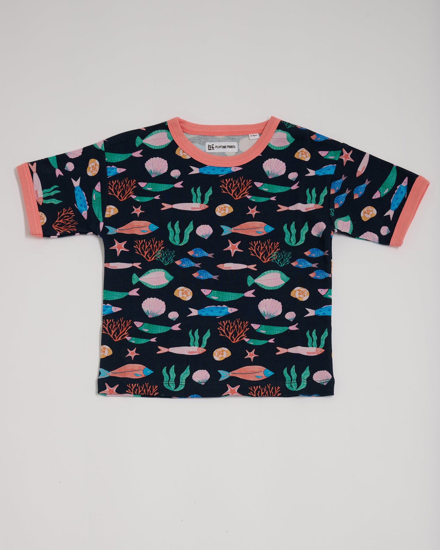 Front of short sleeved t-shirt featuring an all over vibrant navy fish print with contrast coral neck and sleeve trim.