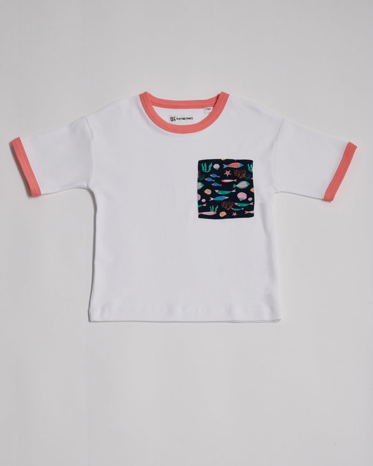 Front of white short sleeved t-shirt with vibrant fish print square chest pocket and coral neck and sleeve trim.