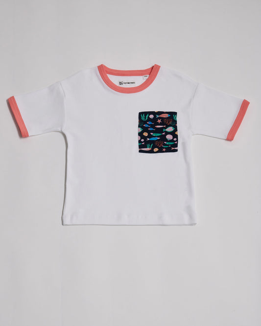 Front of white short sleeved t-shirt with vibrant fish print square chest pocket and coral neck and sleeve trim.