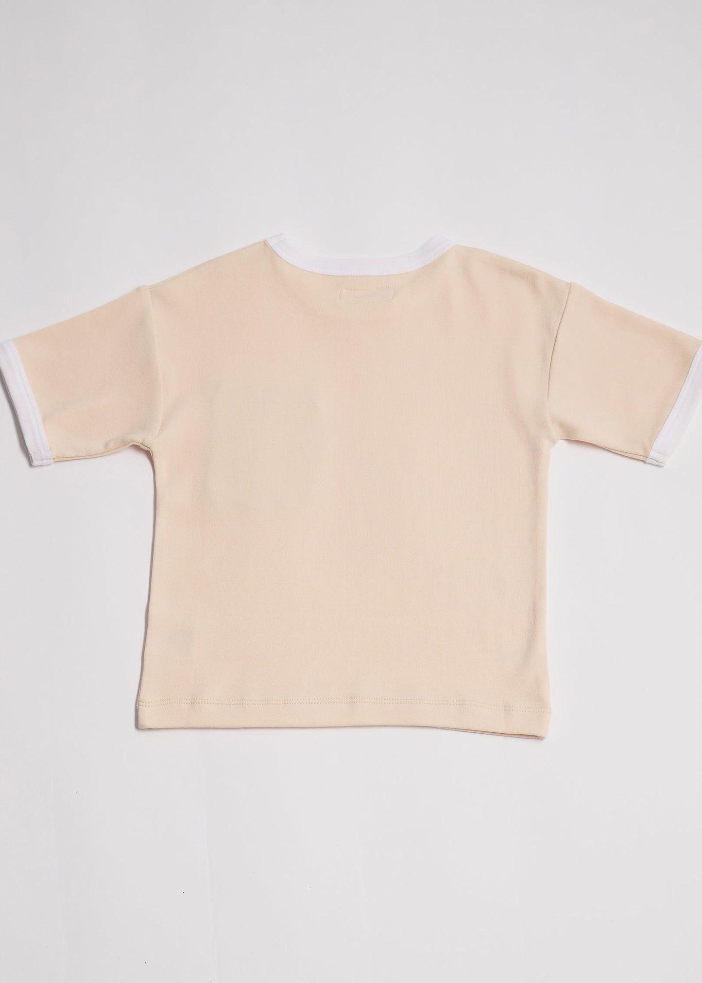 Back of vanilla coloured short sleeved t-shirt with white neck and sleeve trim.