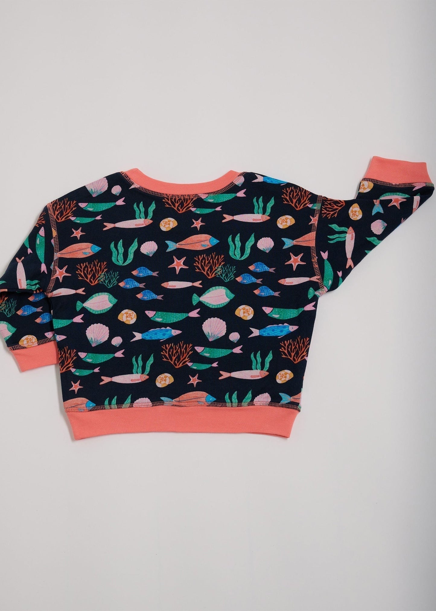 Back of featuring an all over vibrant navy fish print with contrast coral neck and sleeve trim.