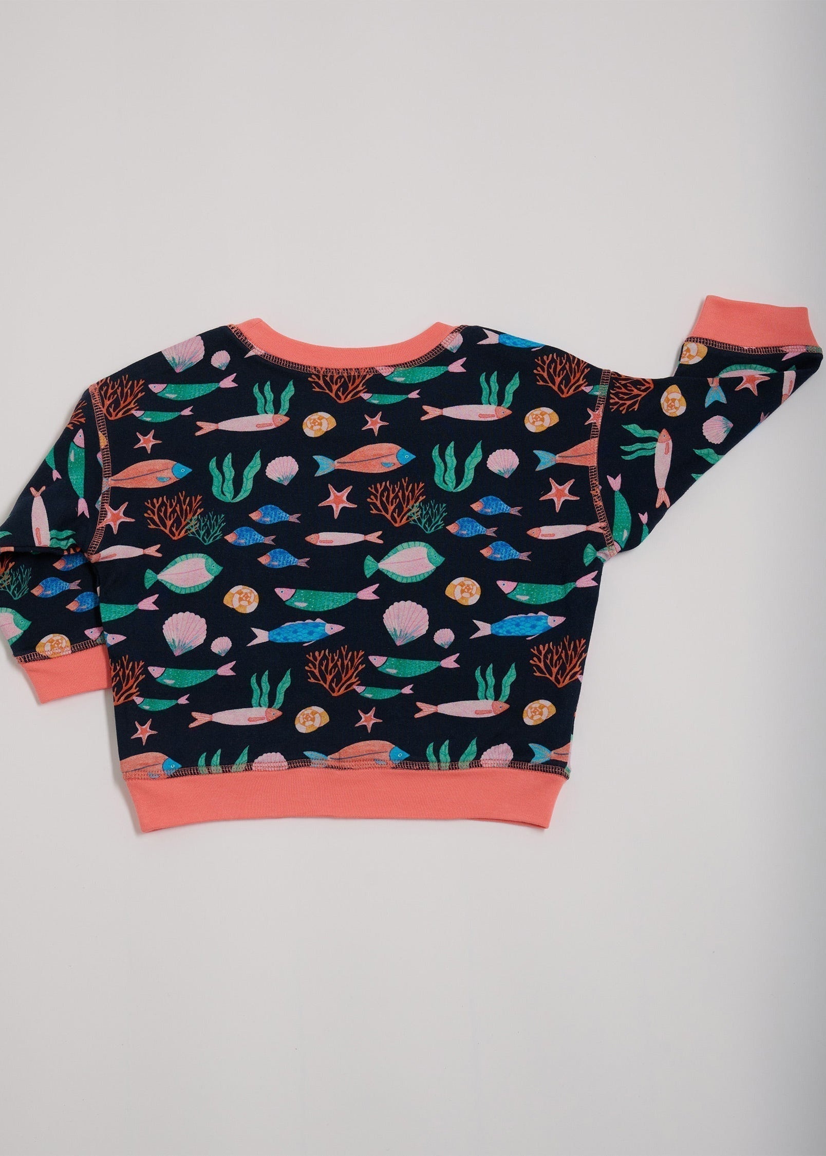 Back of featuring an all over vibrant navy fish print with contrast coral neck and sleeve trim.